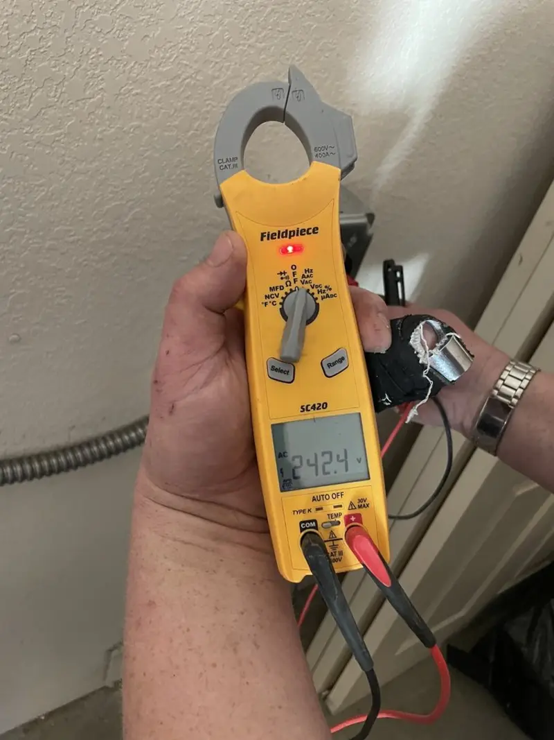 Voltage testing with clamp meter during Outlet Installation in Pine Manor